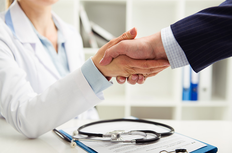 Healthcare partners shaking hands — community collaboration